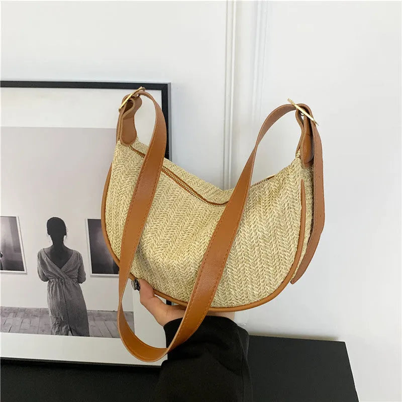 Women's straw woven crossbody bag showing woven texture and internal phone pocket
