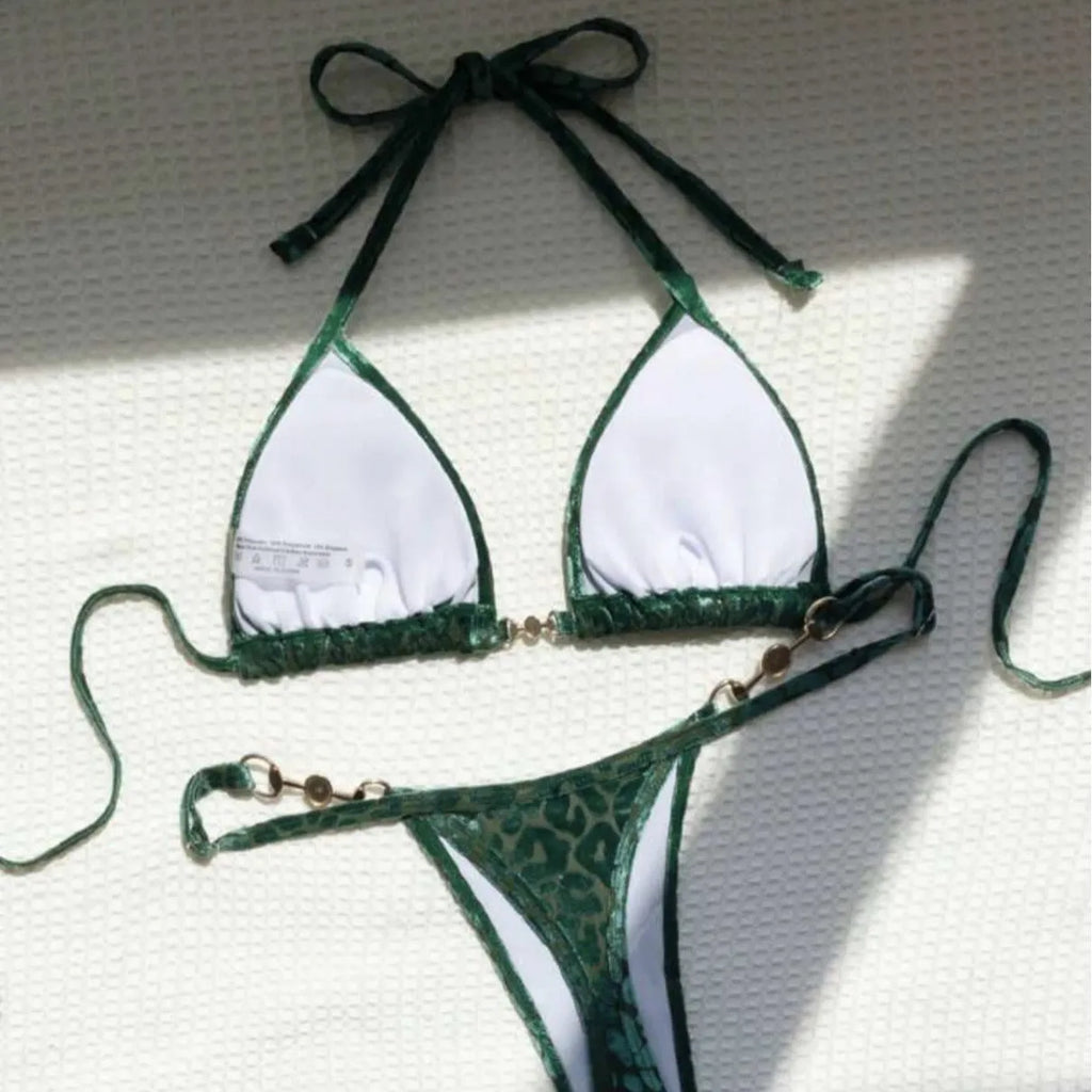Women's T-shaped leopard print bikini swimsuit in polyester and spandex fabric on a mannequin.