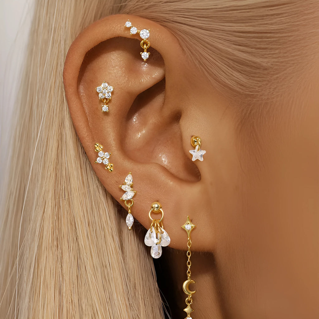 S925 sterling silver geometric moon and star earrings with diamond detail on a gold tone background.