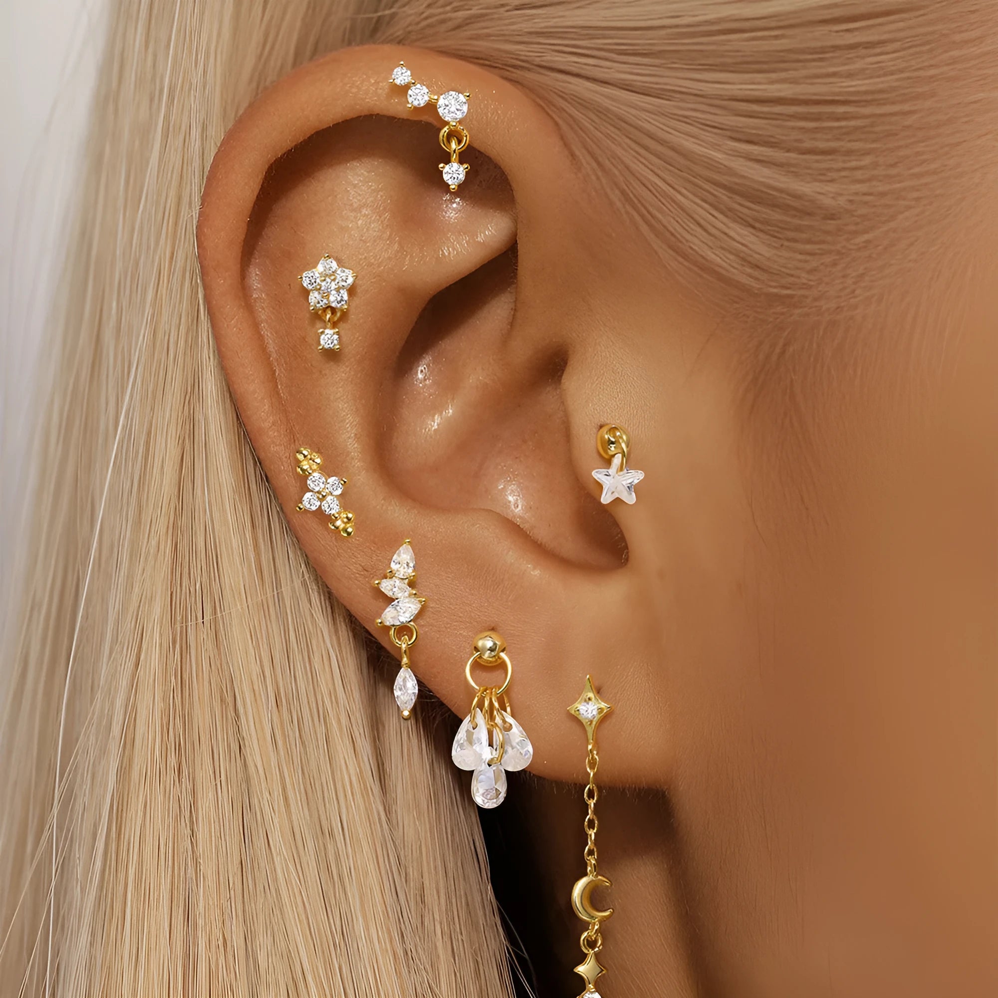 S925 sterling silver geometric moon and star earrings with diamond detail on a gold tone background.