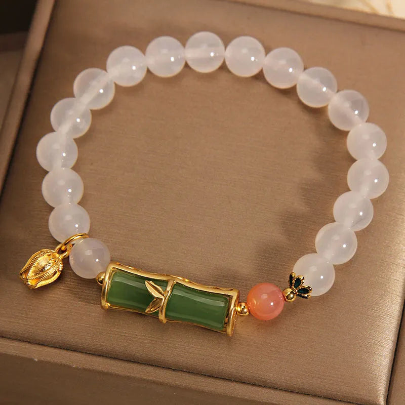 White agate and jade bamboo beaded bracelet with jasper accents on a neutral background.
