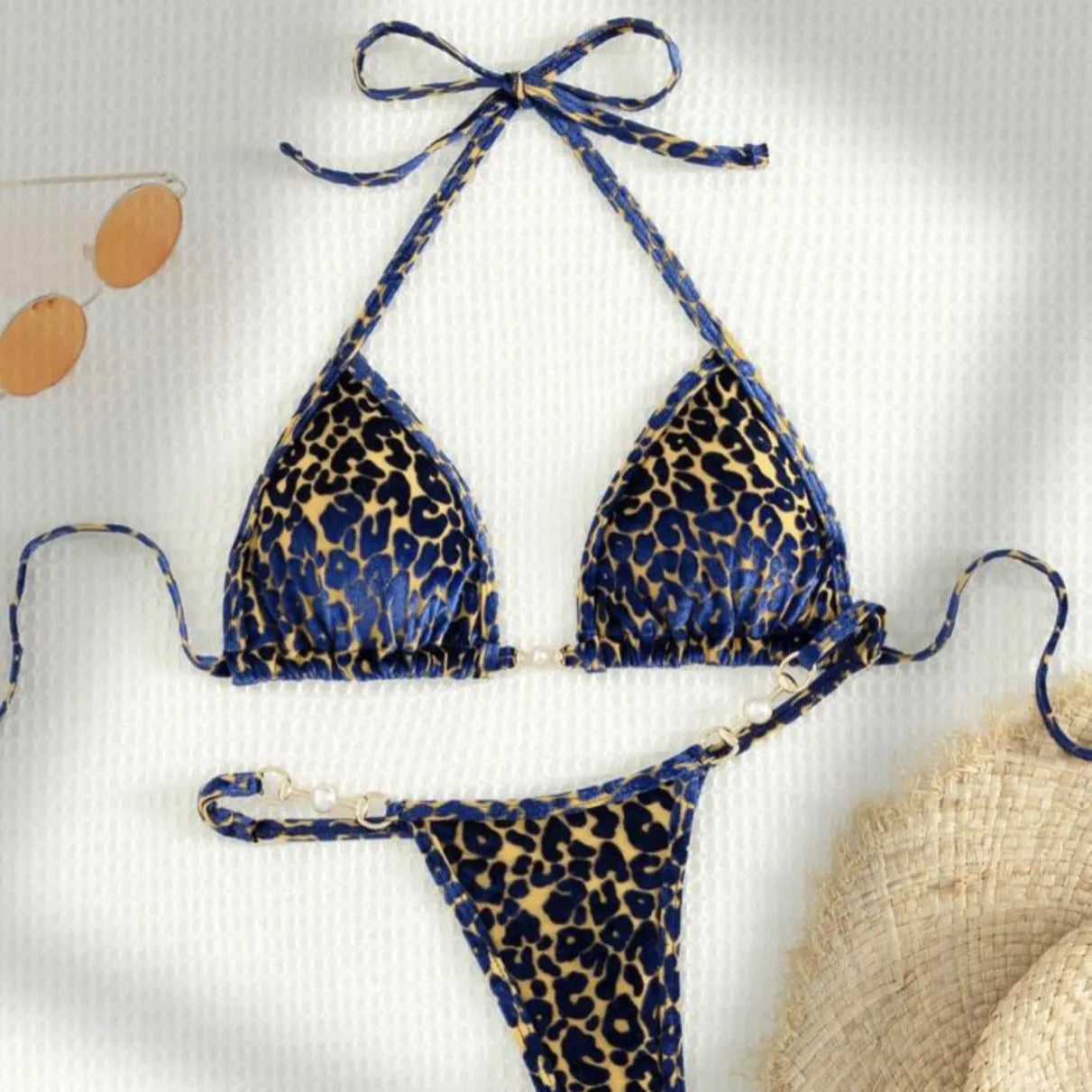 Women's T-shaped leopard print bikini swimsuit in polyester and spandex fabric on a mannequin.