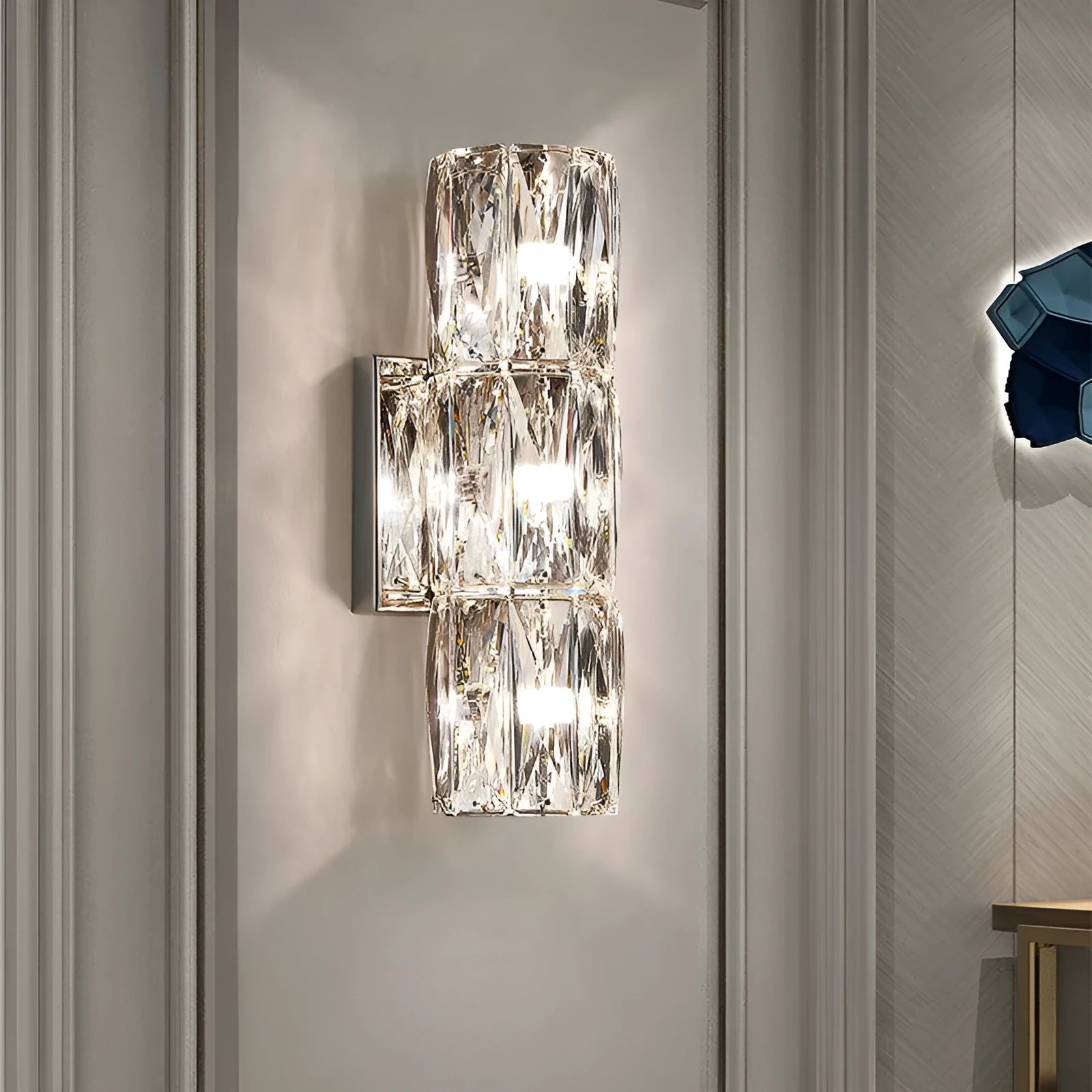 Crystal shade LED wall lamp in chrome or gold finish on stainless steel base.