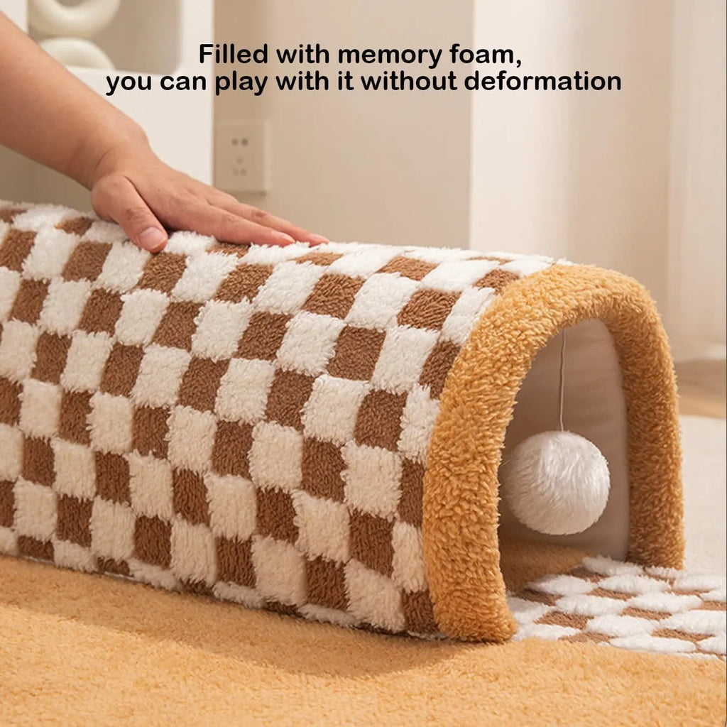 Large fan-shaped plush pet bed with attached tunnel in coffee colour on a wooden floor