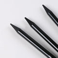 Set of nine wooden artist pencils including graphite and carbonized types on suction card packaging