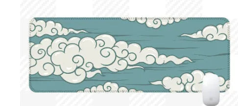 Large cloud pattern mouse pad with non-slip rubber base on a desk