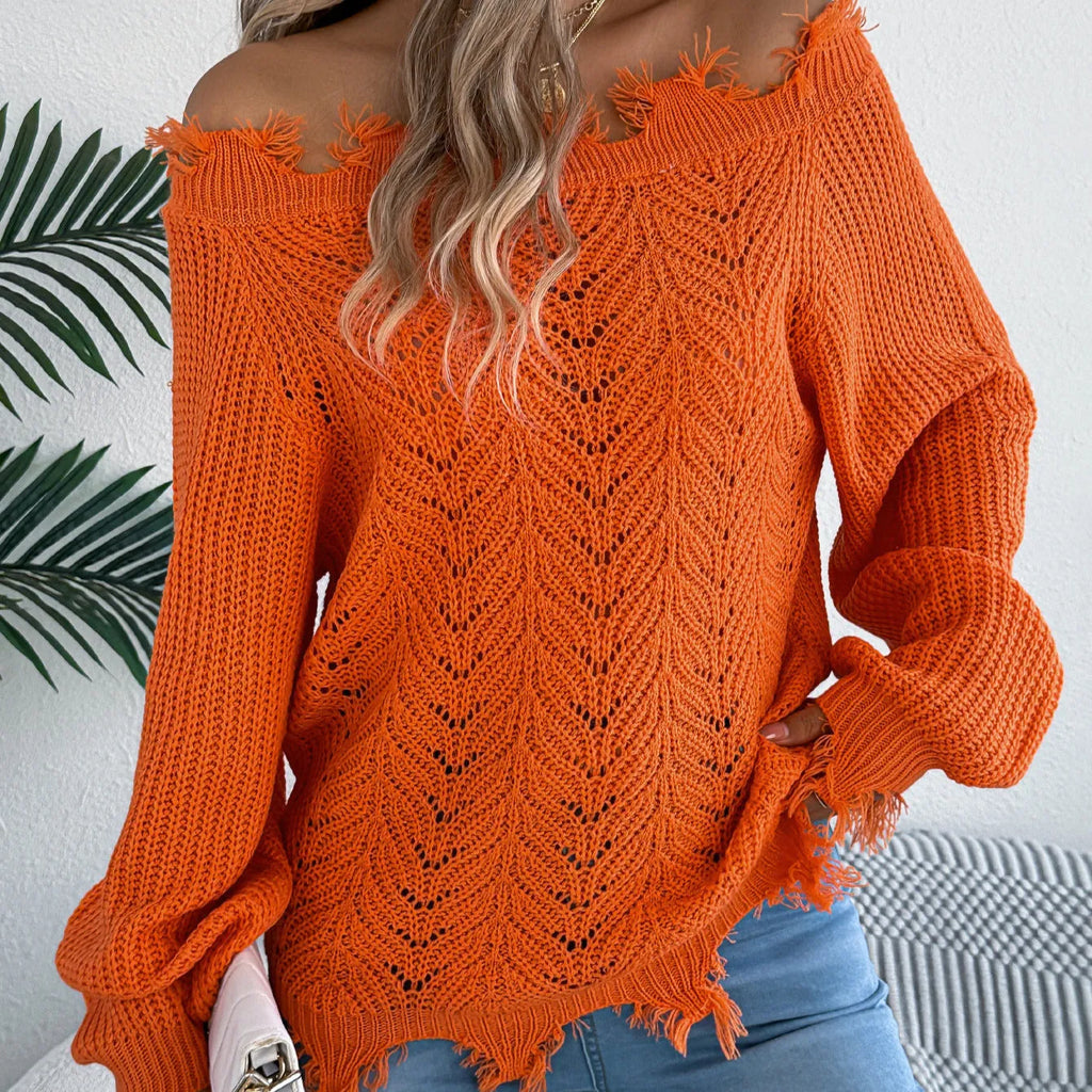 White hollow-out cut off-the-shoulder pullover sweater with long sleeves on a hanger.