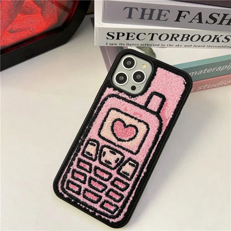 Pink TPU iPhone case with embroidered towel pattern design on the back.