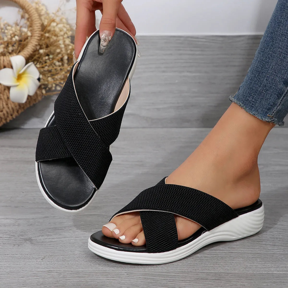 Women's black peep-toe wedge slippers with thick rubber sole showing fish mouth scaffold shape