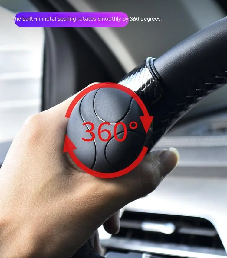 Black silicone steering wheel assist ball with metal bearing, shown next to a blue version.