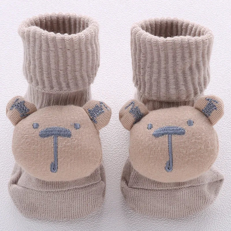 Cotton baby floor socks with non-slip soles in a pink bow print design.
