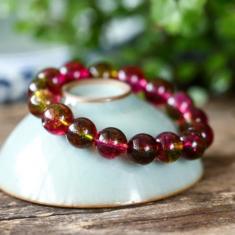 Handmade watermelon crystal bracelet for women on a wrist, showing pastoral design details.
