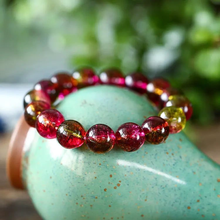 Handmade watermelon crystal bracelet for women on a wrist, showing pastoral design details.