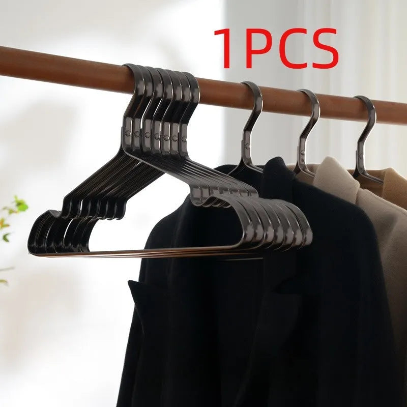 Elegant black modern clothes hanger with non-slip shoulders on a white background.