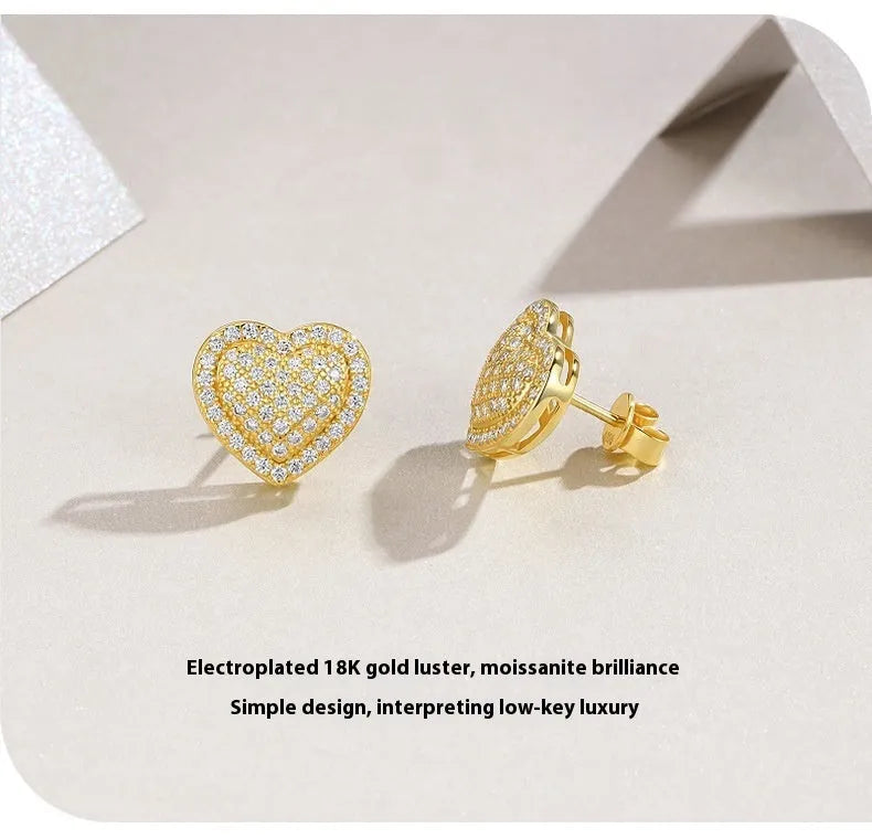 Simple heart-shaped stud earrings made of S925 silver with moissanite, shown in a gold colour.
