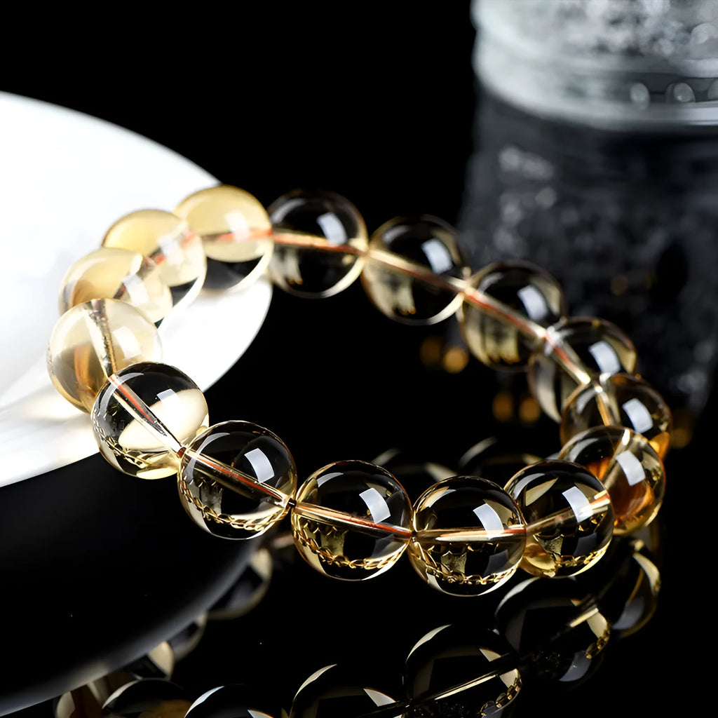 Natural citrine scattered beads ball bracelet showing polished yellow stone beads on wrist.