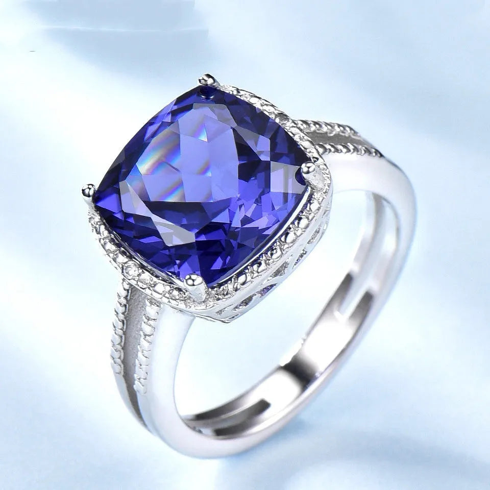 Women's sterling silver ring with blue tanzanite gemstone showing silver band and stone setting