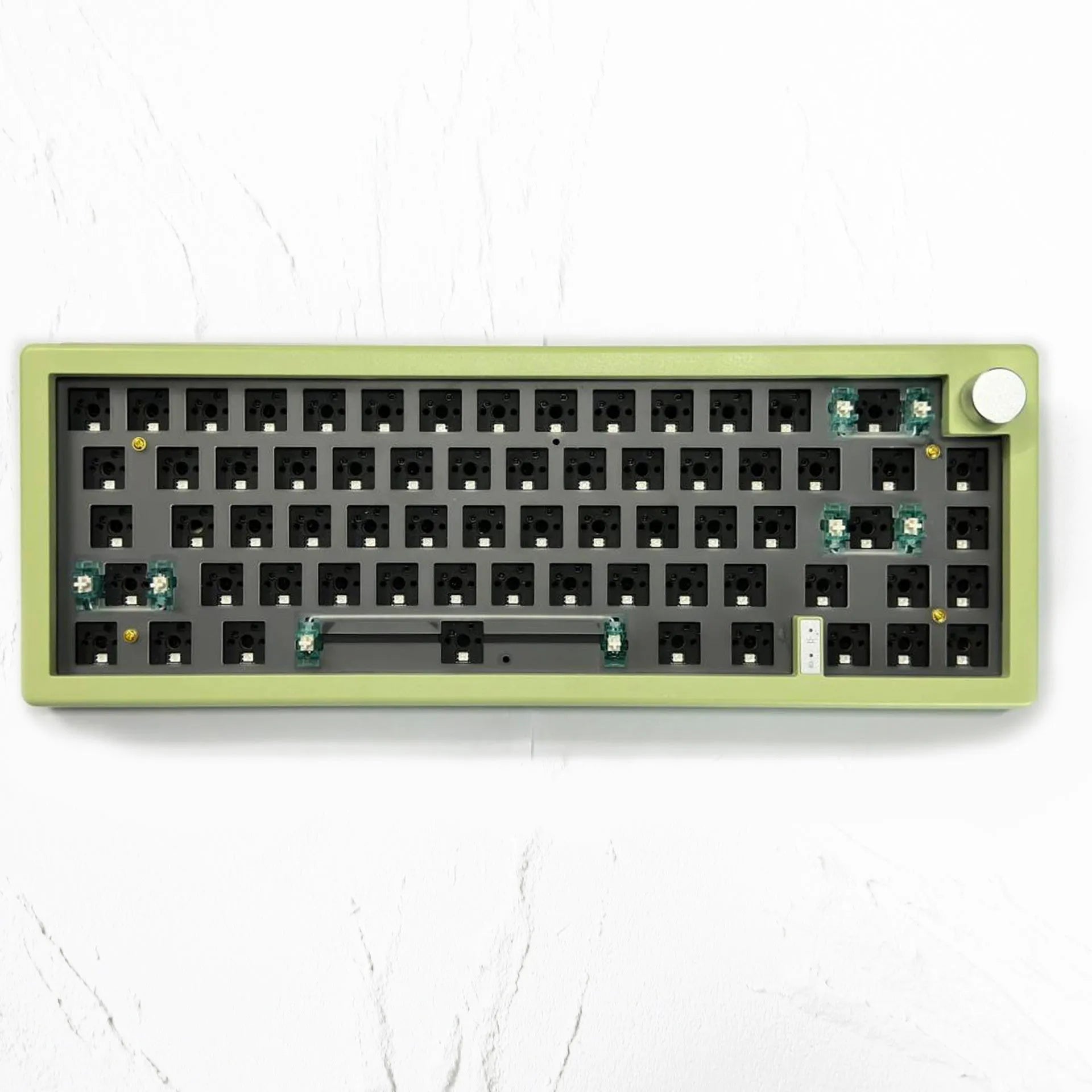 DIY mechanical keyboard kit components with RGB keys and knob on a black ABS case.