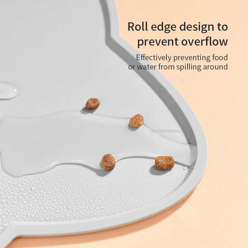 Blue silicone pet feeding mat for dog or cat bowls on a wooden floor.