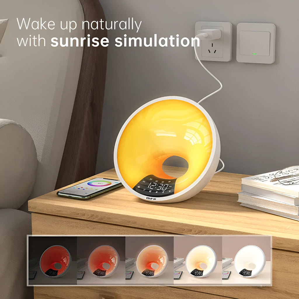 White WiFi smart sunrise alarm clock with dual alarm, FM radio, Bluetooth, and adjustable light on a bedside table