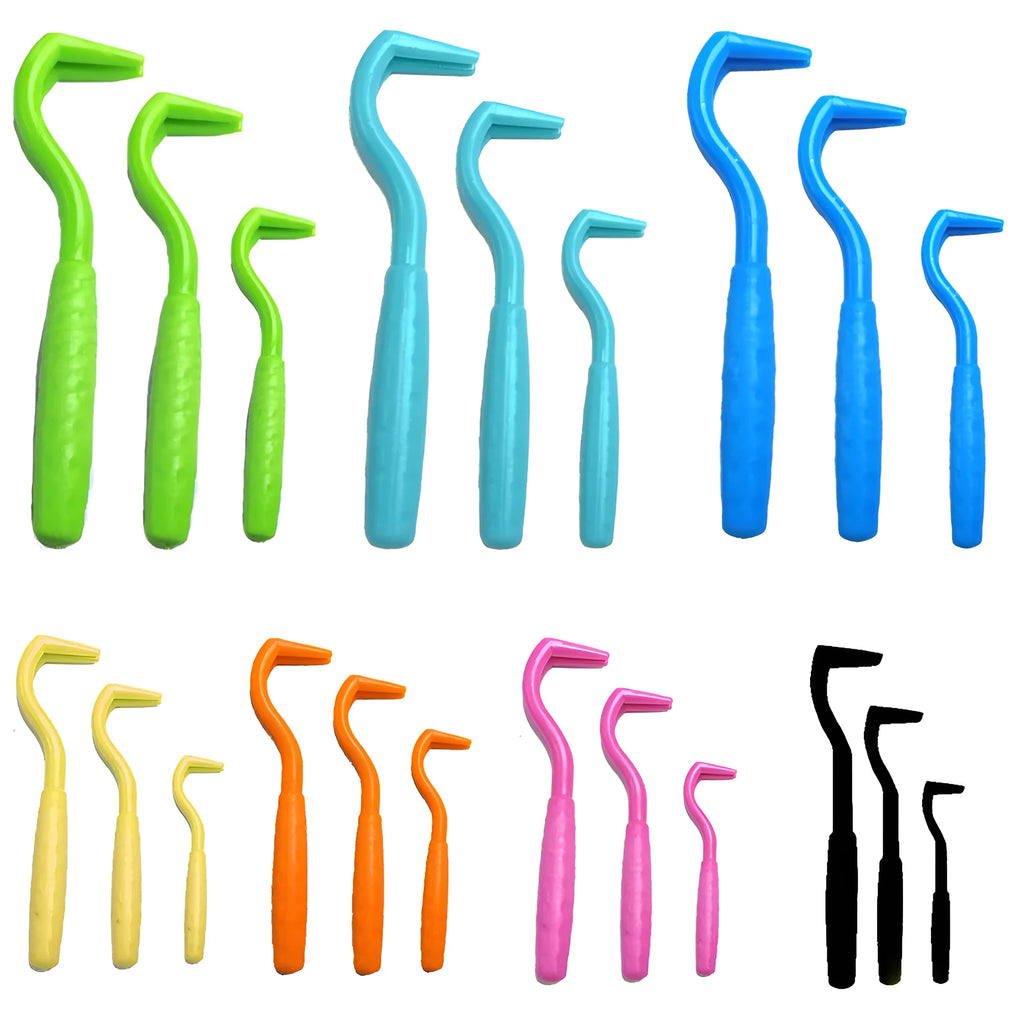 Pack of three coloured plastic tick removal hooks for dogs on a plain background.