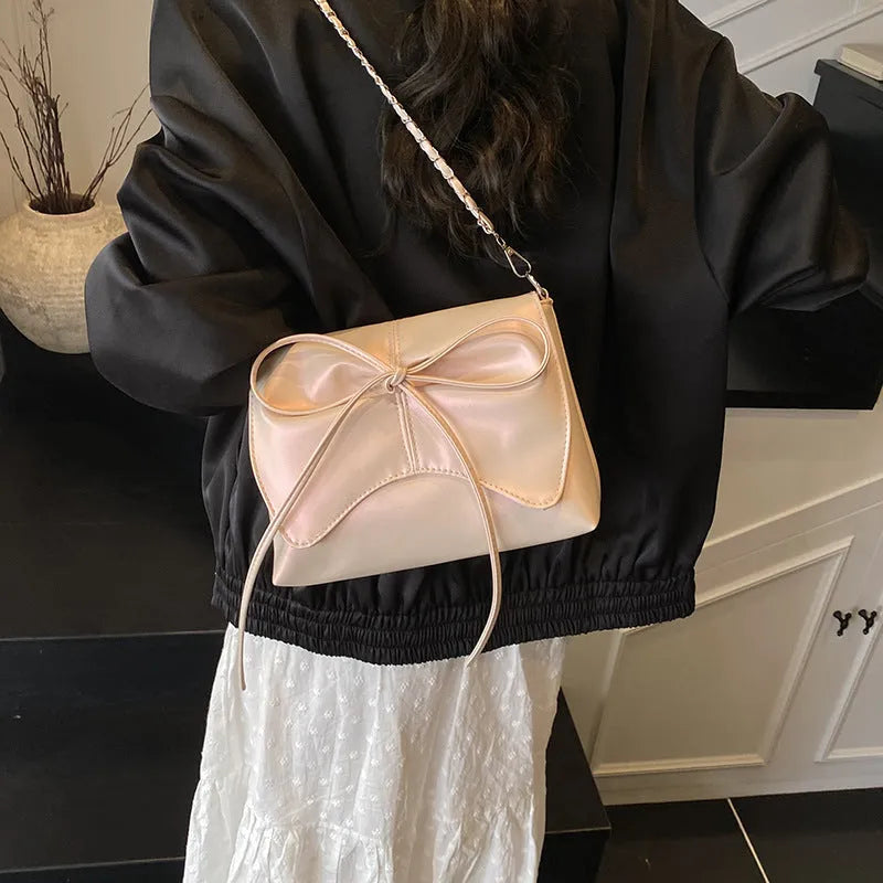 Women's black PU leather crossbody underarm bag with horizontal square shape and visible sewing lines.