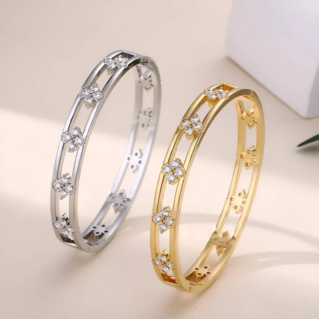 Gold and silver women's bracelets with hollow design and four-leaf clover zircon charms.
