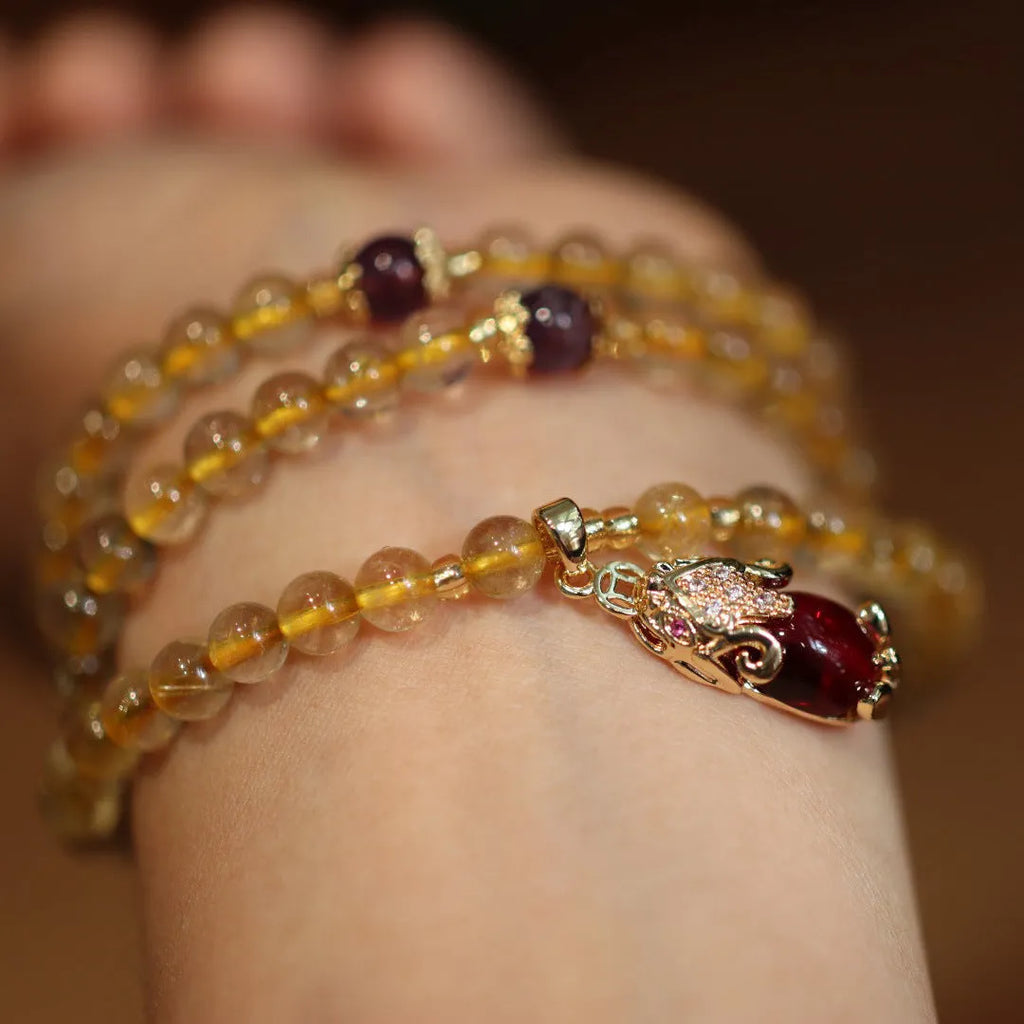 Handmade gold rutilated quartz bracelet with Chinese style design and three-circle pattern.
