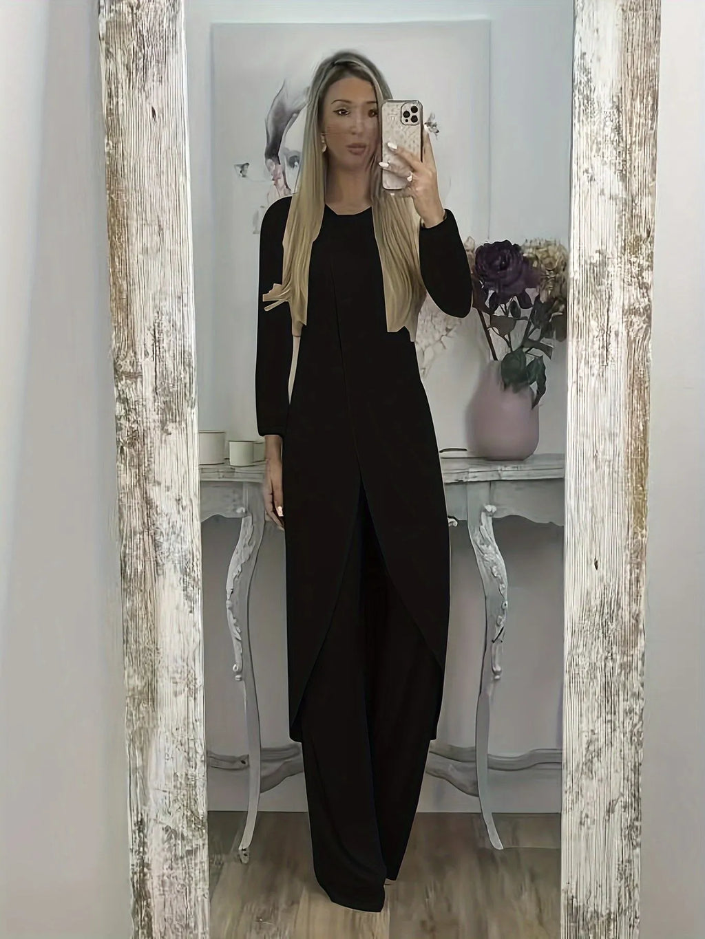 Black loose fit casual two-piece lounge set with long sleeve top and trousers on a hanger.