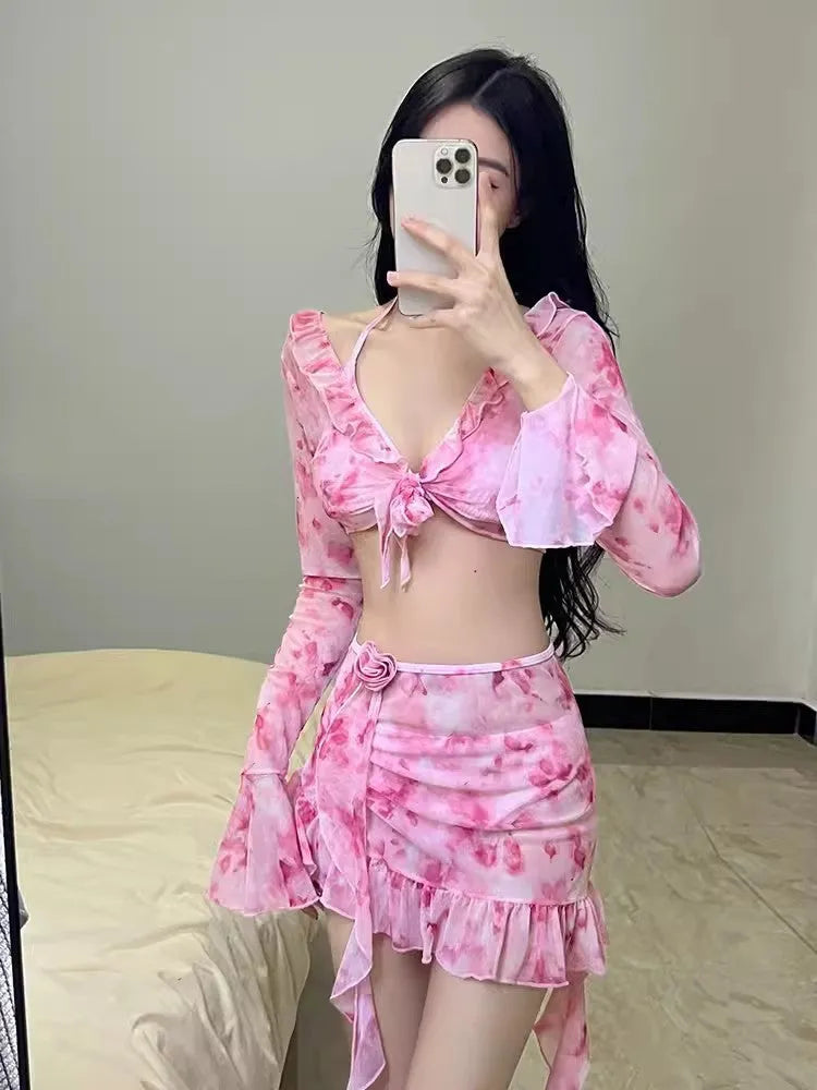 Women's cherry blossom pink floral bikini swimsuit laid flat.