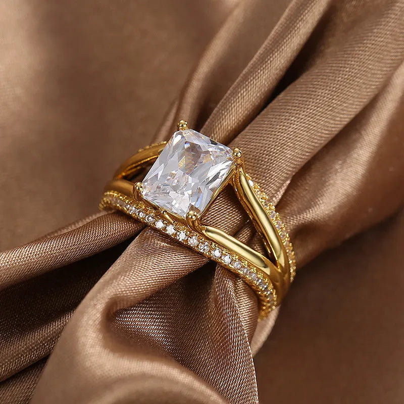 Gold electroplated copper ring with square zircon stone in geometric design, showing side profile