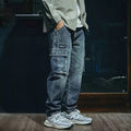 Men's blue loose straight cut retro denim pants with stretch fabric and zip fly, laid flat