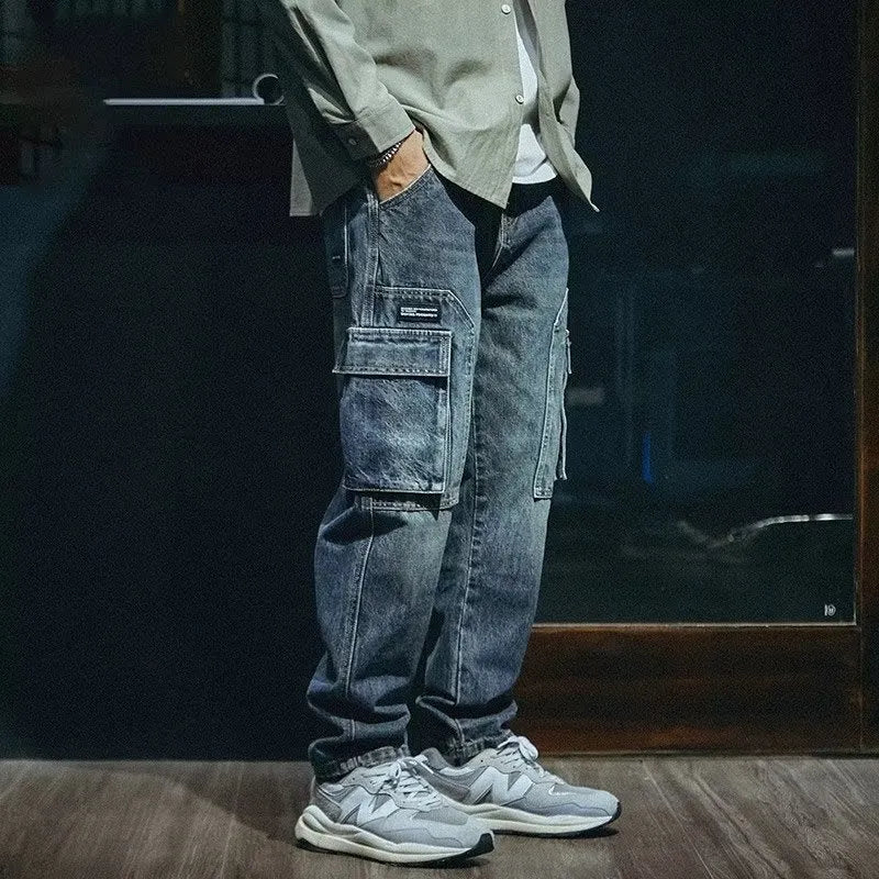 Men's blue loose straight cut retro denim pants with stretch fabric and zip fly, laid flat