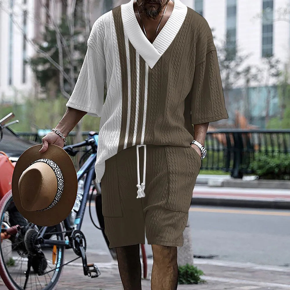 Man wearing a printed drop-shoulder knitted short-sleeve top and matching shorts in a casual setting.