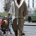 Man wearing a printed drop-shoulder knitted short-sleeve top and matching shorts in a casual setting.