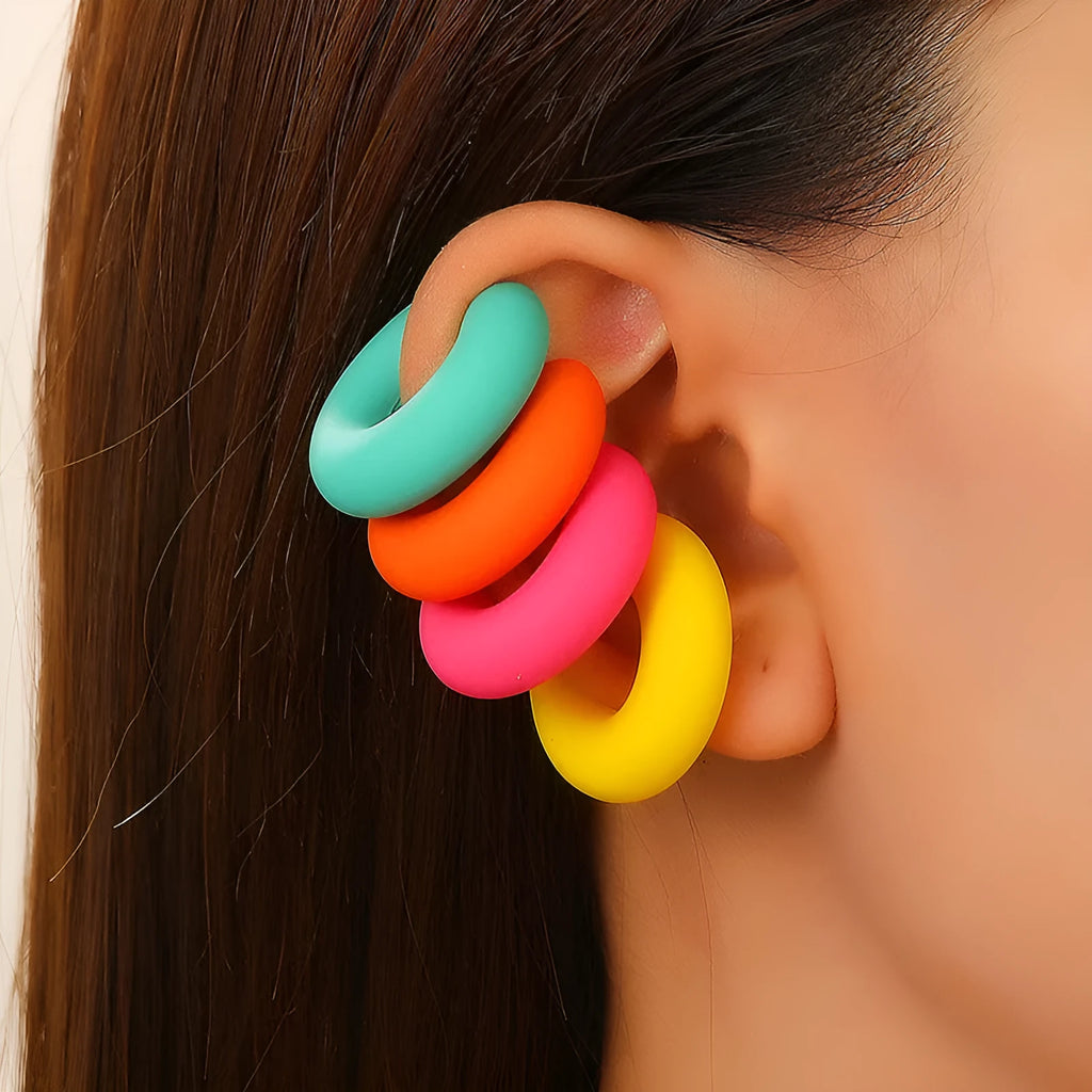 A pair of matte coarse finish round C-shaped clip-on earrings for women, shown in a candy colour.