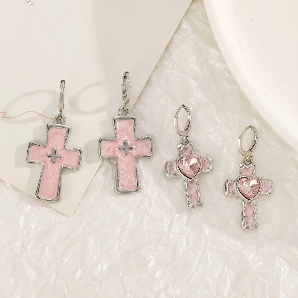 Women's alloy earrings showing cross, heart, and cat designs in white, black, and antique silver finishes.