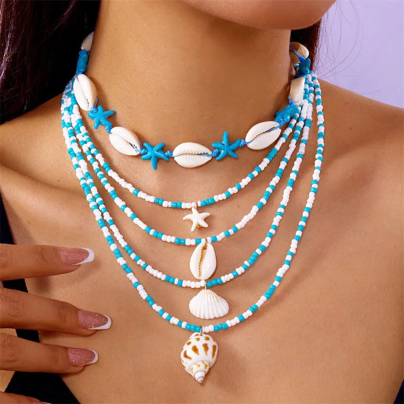 Five women's necklaces with shell and conch bead pendants on adjustable electroplated alloy chains