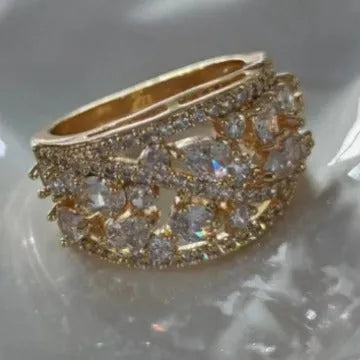 Women's round hollow fashion ring in gold or platinum with a white diamond or navy blue sapphire stone.