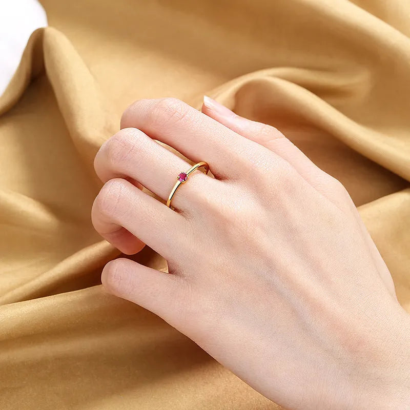 Twin style women's copper ring with a single round diamond, shown in blue, green, red, and white colour options.