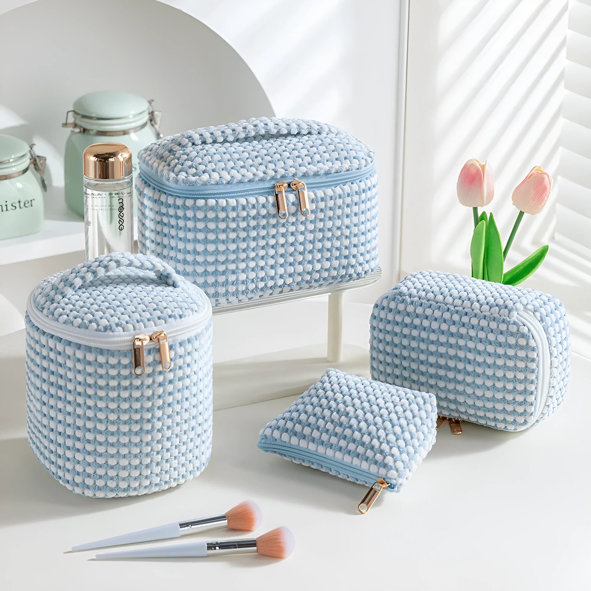 Four cube-style flannelette makeup bags in coordinating colours showing portable cosmetic organiser set