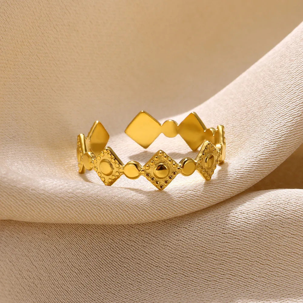 Gold geometric titanium steel ring with a diamond accent for women.