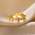 Gold geometric titanium steel ring with a diamond accent for women.