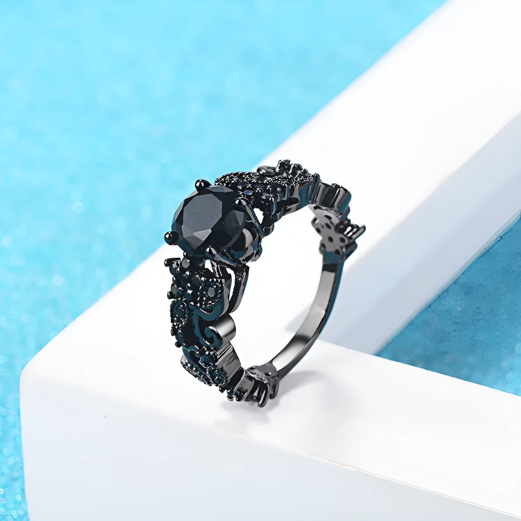 Unisex copper punk electroplated black gold ring with inlaid black zircon stone and olive branch motif on black background