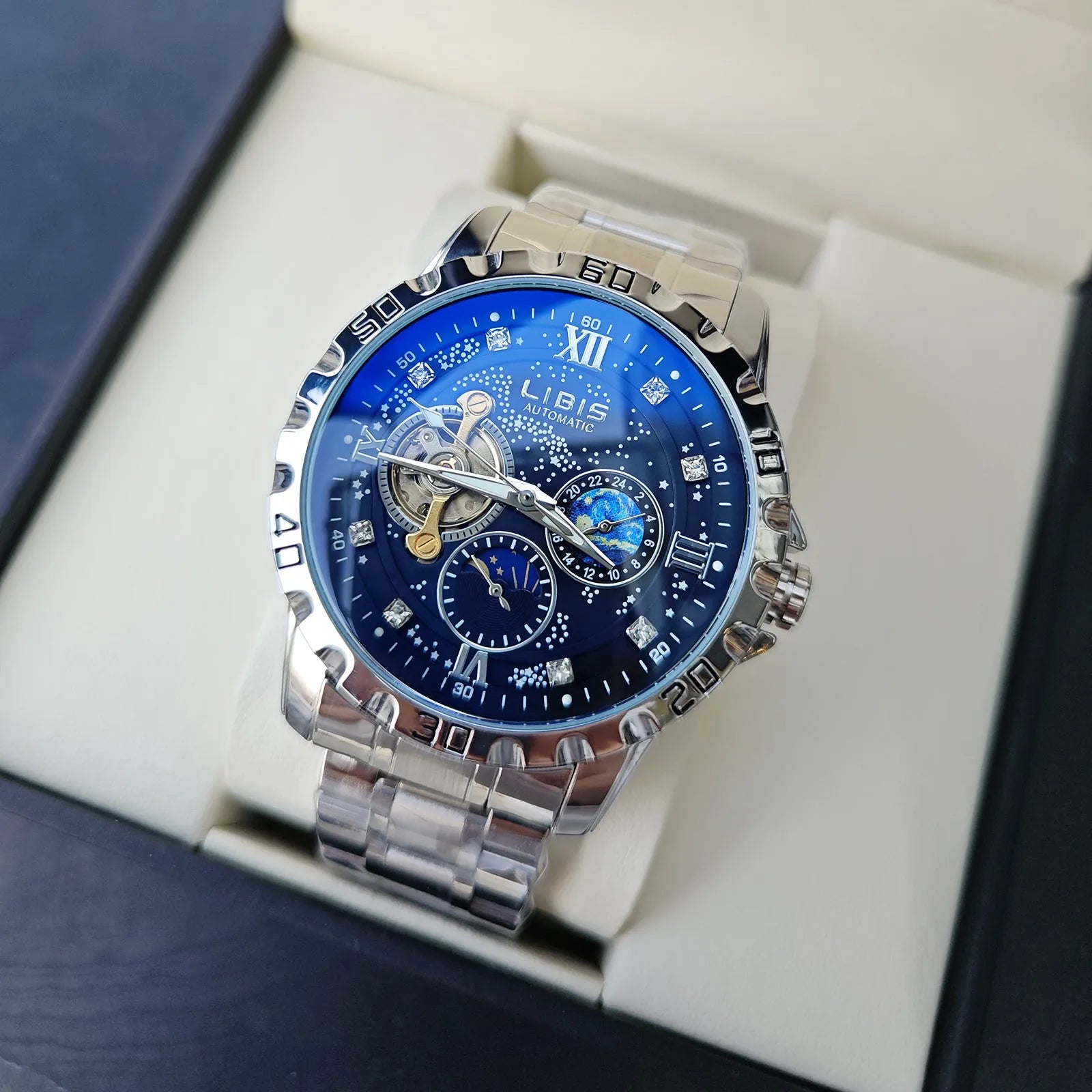 Men's silver case automatic watch with black starry dial, luminous hands, and brown leather strap