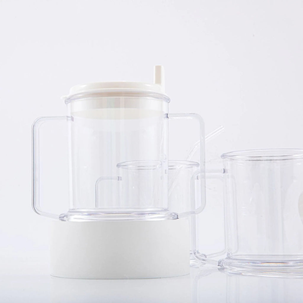 Transparent plastic drinking cup with a black spill-proof lid on a white background