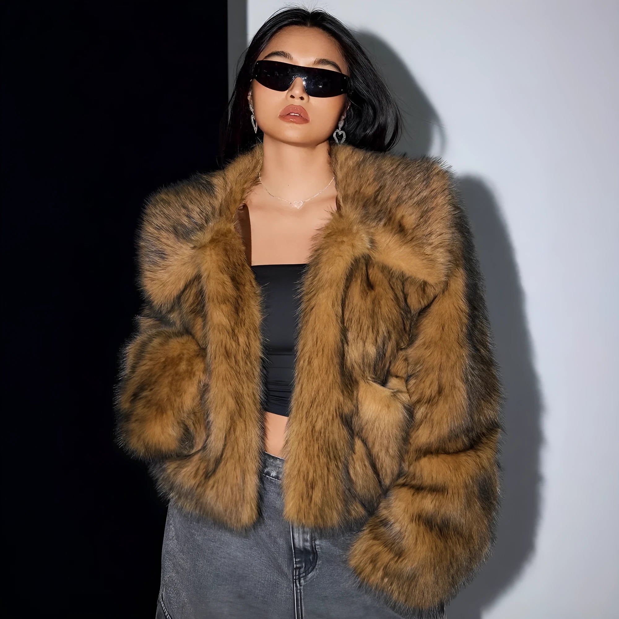Women's short length artificial fur coat with a fur collar in a black tip on black background colour.