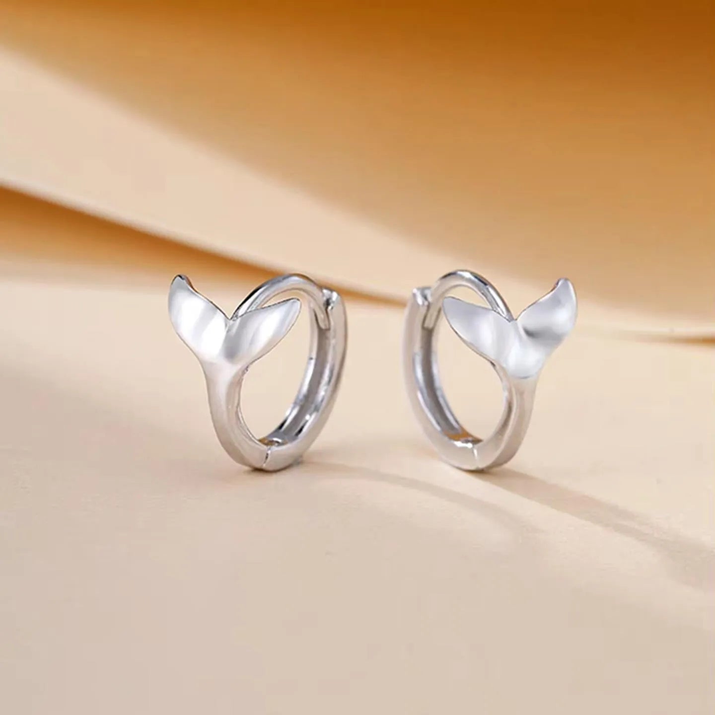 A pair of simple fishtail design earrings in a choice of white gold or yellow gold colour.