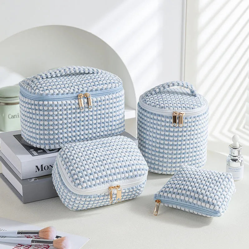 Four cube-style flannelette makeup bags in coordinating colours showing portable cosmetic organiser set