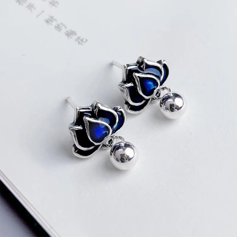 Blue lotus ear studs with seedpod tassel design and retro artistic style